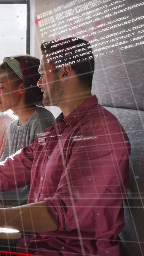 Vertical video: Man tapping laptop collaborating grid code appearing red or blue Stock Footage 333649931