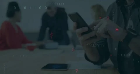 Vertical video: Man tapping phone in tech meeting, creating floating binary code Stock Footage 331048528