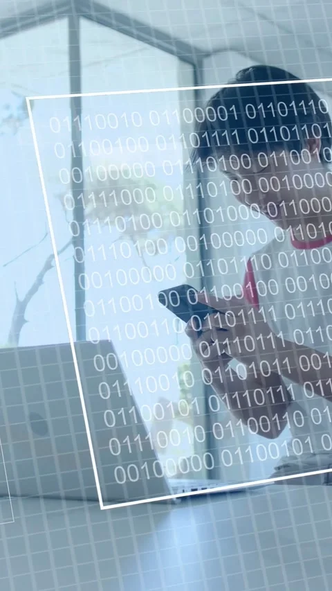 Vertical video: Man tapping phone at table starting charts and code moving to Stock Footage 333658451