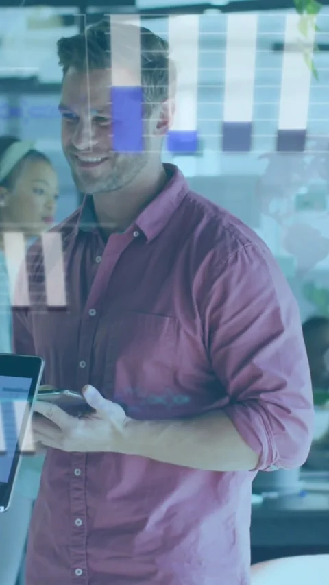 Vertical video: Man tapping phone, glancing at laptop and creating chart bars on Stock Footage 334317651