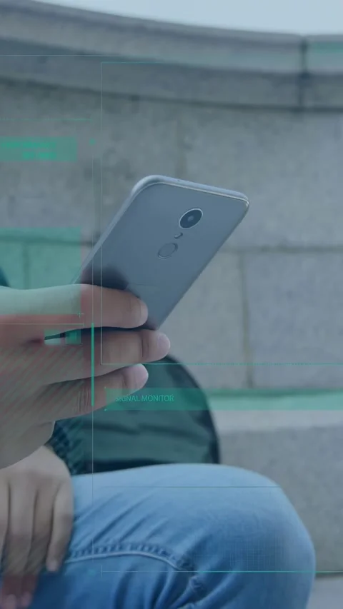 Vertical video: Man tapping phone checking map, teal tech HUD showing cam Stock Footage 334392281