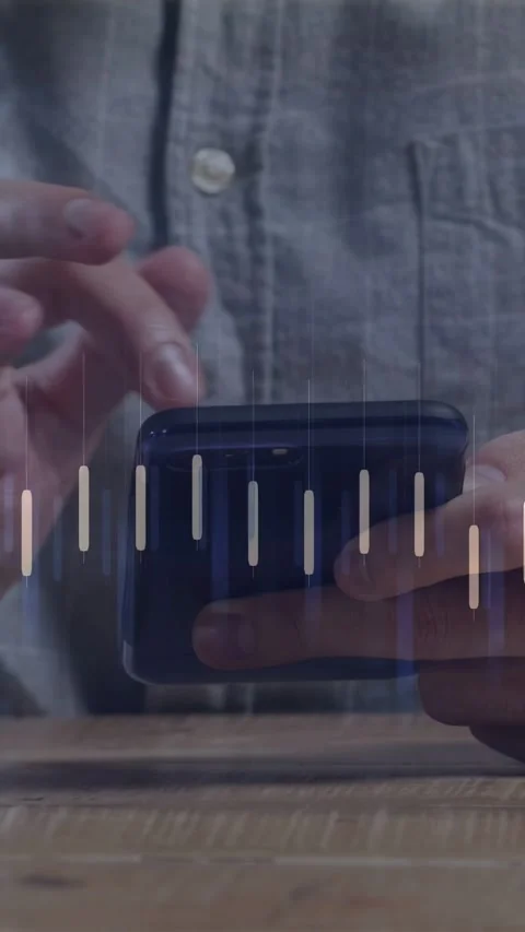 Vertical video: Man tapping phone on wood table causing finance graph dipping Stock Footage 334770613