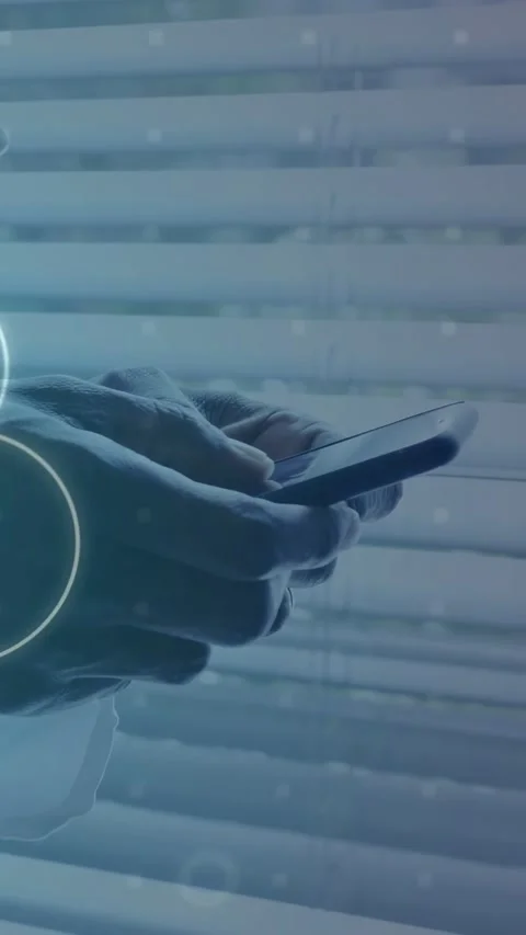 Vertical video: Man tapping phone against blinds starting tech binary overlay Stock Footage 334792498