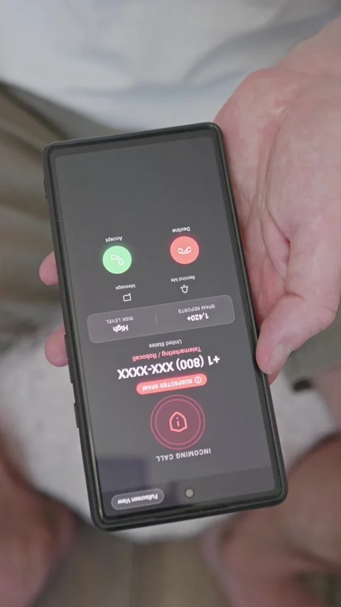 Vertical video. Man tapping screen to block and report a scam caller on a Stock Footage 341860784