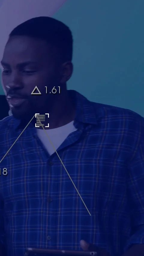 Vertical video: Man tapping tablet checking metrics at tech desk causing tri Stock Footage 329841069
