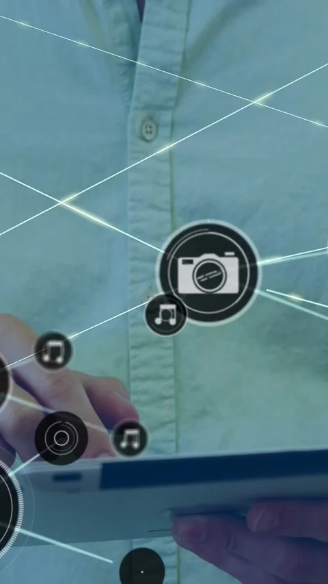 Vertical video: Man tapping tablet, camera icon popping, forming tech network Stock Footage 329913211
