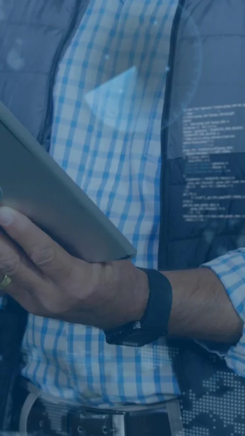 Vertical video: Man tapping tablet, making tech code overlay while camera Stock Footage 331790405