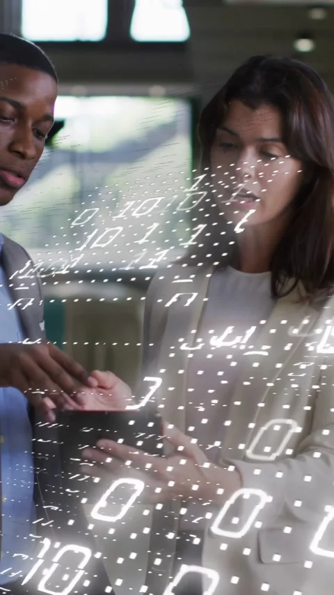 Vertical video: Man tapping tablet, woman leaning in, showing dotted binary Stock Footage 332846224