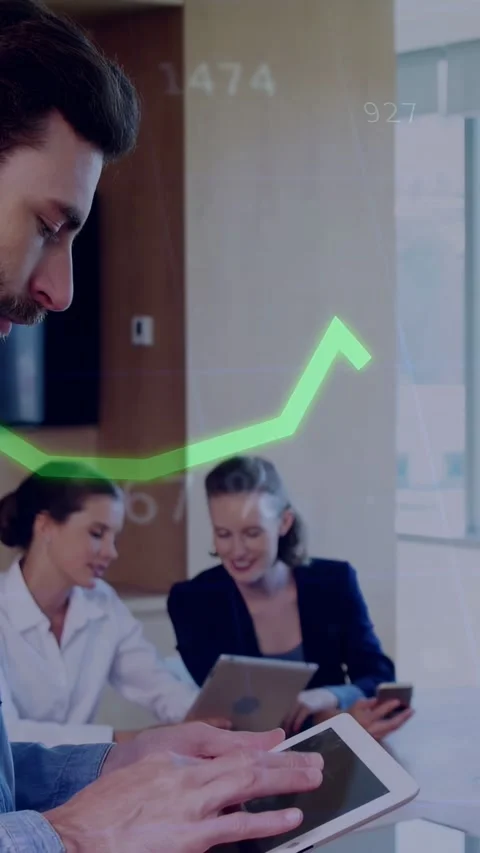 Vertical video: Man tapping tablet making tech graphs move while team using Stock Footage 333236567