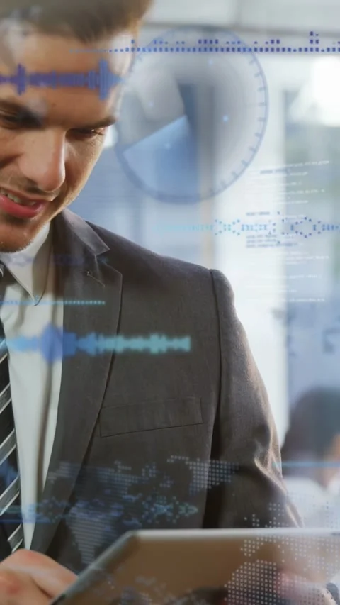 Vertical video: Man tapping tablet in tech office making code UI and charts sync Stock Footage 333259692