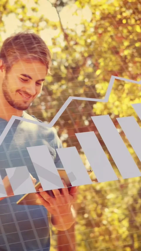 Vertical video: Man tapping tablet in park, analyzing tech overlay with pie bar Stock Footage 333896467