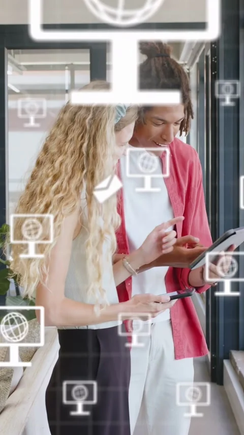 Vertical video: Man tapping tablet at window making tech icons floating as woman Stock Footage 340133529