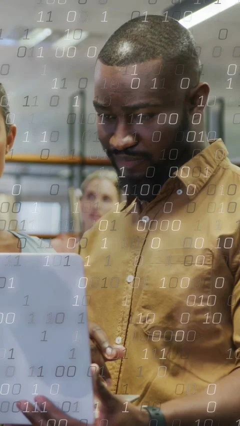 Vertical video: Man tapping white laptop, binary overlay densifying as team Stock Footage 337538898