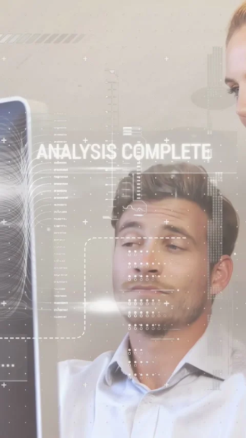 Vertical video: Man in tech reviewing results on screen, HUD scanning face while 스톡 동영상 332278015