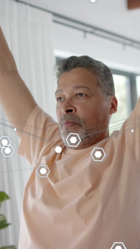 Vertical video: Man testing tech by lowering raised arms to shoulder level, hex Stock Footage 333978328