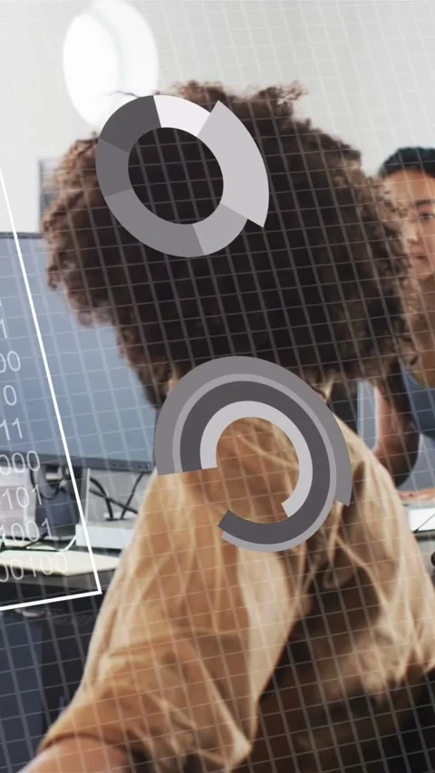 Vertical video: Man turning at desk as woman typing causing HUD data bars on Stock Footage 333777166