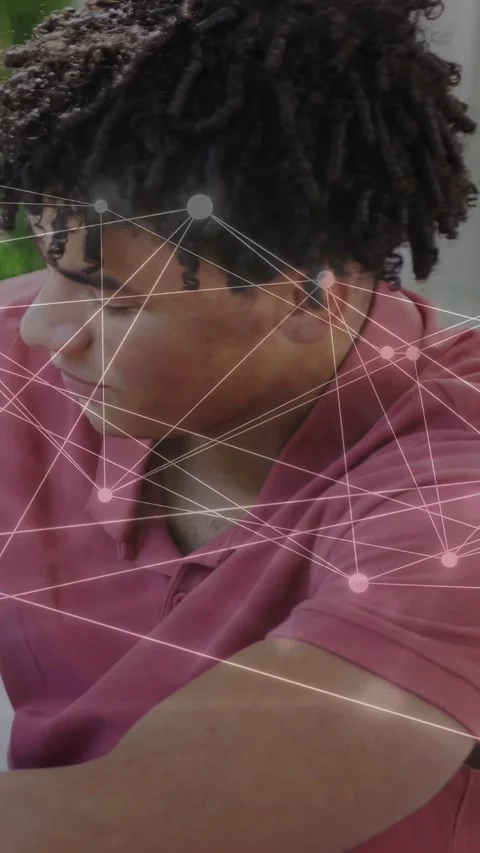 Vertical video: Man turning head and smiling at table as network nodes overlay Stock Footage 333978396