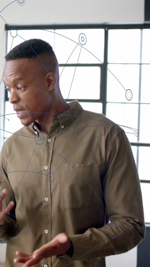 Vertical video: Man turning, making blue tech overlay appear on torso, gesturing Stock Footage 333496205