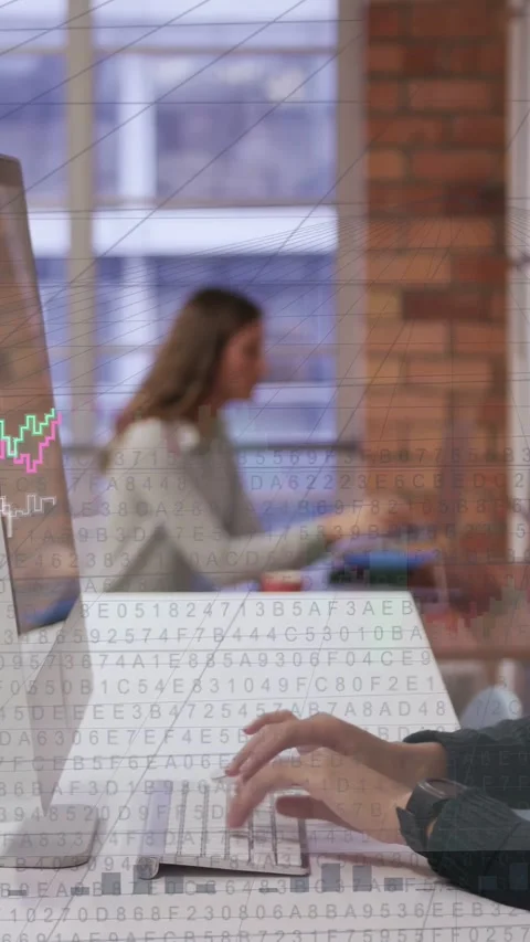 Vertical video: Man typing and initiating animated code and line graphs across Stock Footage 333157560