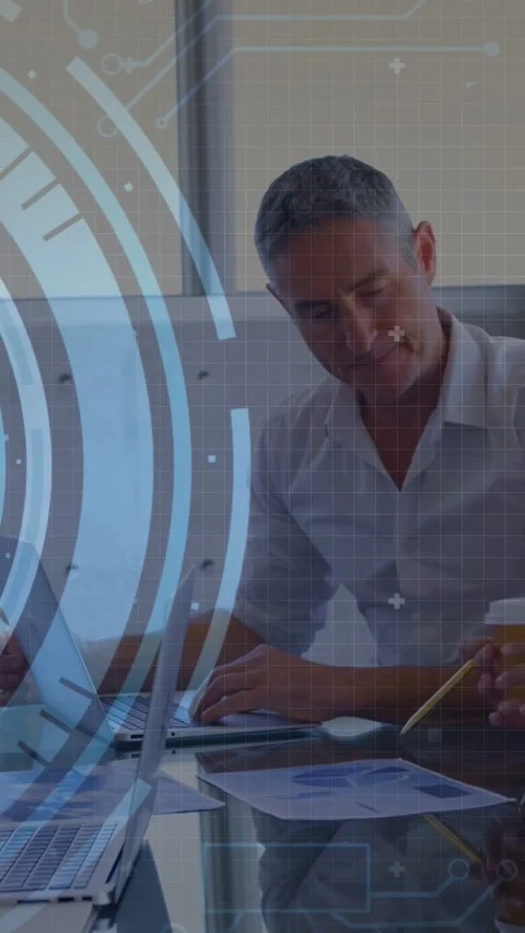 Vertical video: Man typing and following peer pointing at charts HUD code Stock Footage 333556482