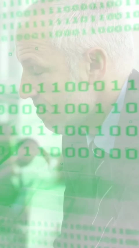 Vertical video: Man typing and leaning revealing face under green binary overlay Stock Footage 334602968