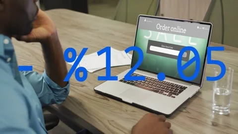 Vertical video: Man typing coupon code, monitoring discount on laptop while Stock Footage 333169527