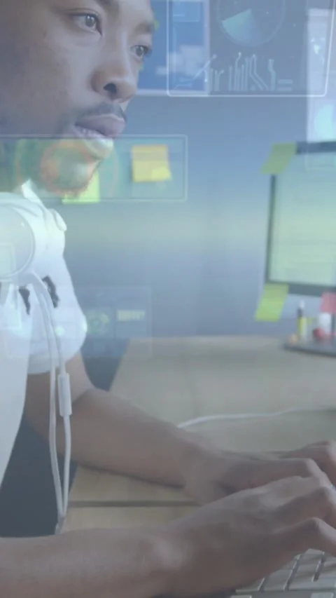 Vertical video: Man typing at desk after prompt, reviewing code to debug as Stock Footage 330509552