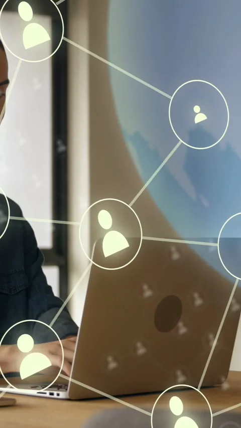 Vertical video: Man typing at desk starting IT icon network spanning laptop Stock Footage 333556860