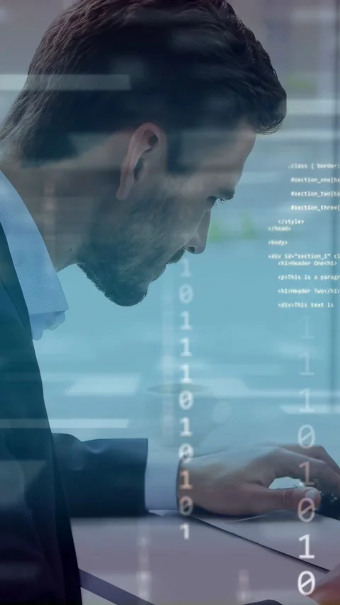 Vertical video: Man typing at desk by window starting animated code and binary Stock Footage 334770699