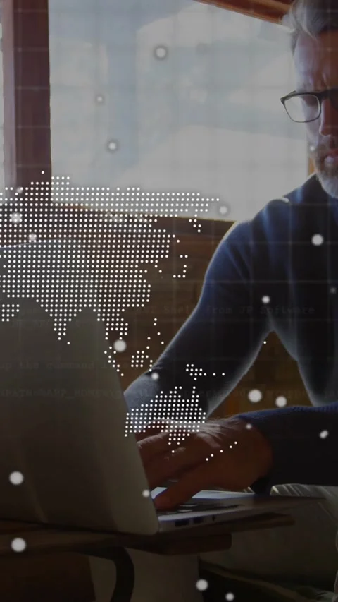 Vertical video: Man typing on laptop, activating world map and console HUD while Stock Footage 328308829