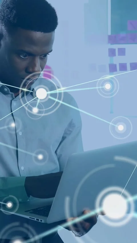 Vertical video: Man typing on laptop in tech office for data, causing Stock Footage 330332645