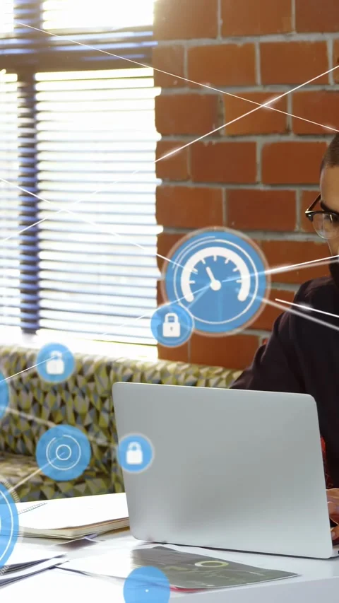 Vertical video: Man typing on laptop in tech, blue HUD icon sparking lock links Stock Footage 332278571