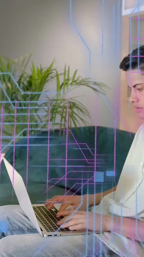 Vertical video: Man typing on laptop on green sofa, activating programming Stock Footage 333542090