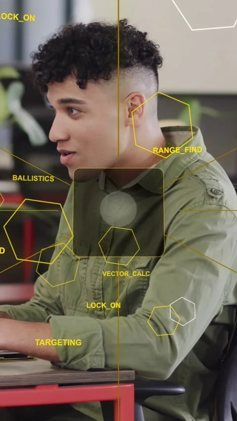Vertical video: Man typing laptop at desk pausing on cue replying while tech HUD Stock Footage 334046807