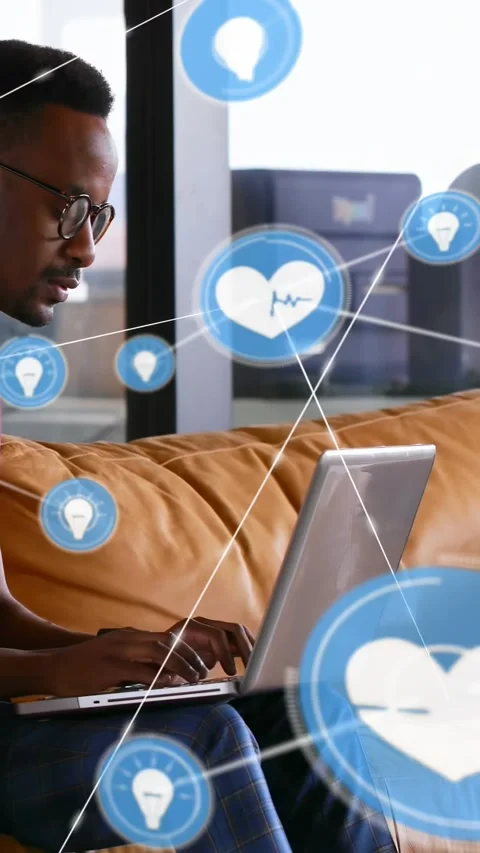 Vertical video: Man typing on laptop in tech, sparking idea and heart icons over Stock Footage 334547363