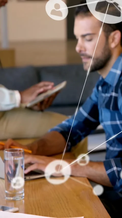 Vertical video: Man typing on laptop starting network node overlay as woman Stock Footage 334600671