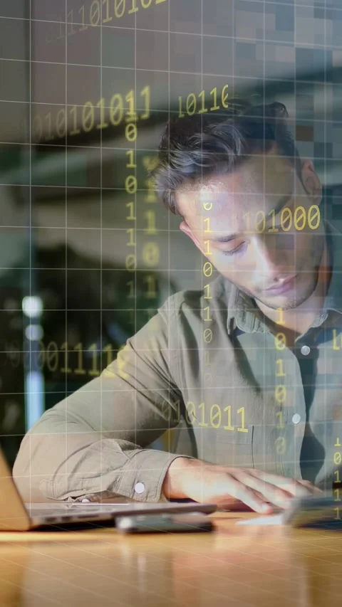 Vertical video: Man typing laptop tapping phone and writing notes causing binary Stock Footage 334694948