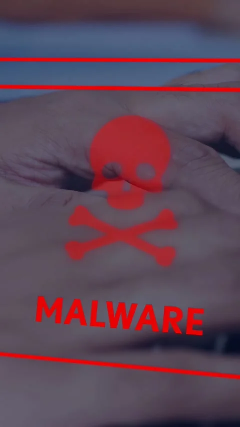 Vertical video: Man typing on laptop keys, red MALWARE warning appearing, Stock Footage 334792480