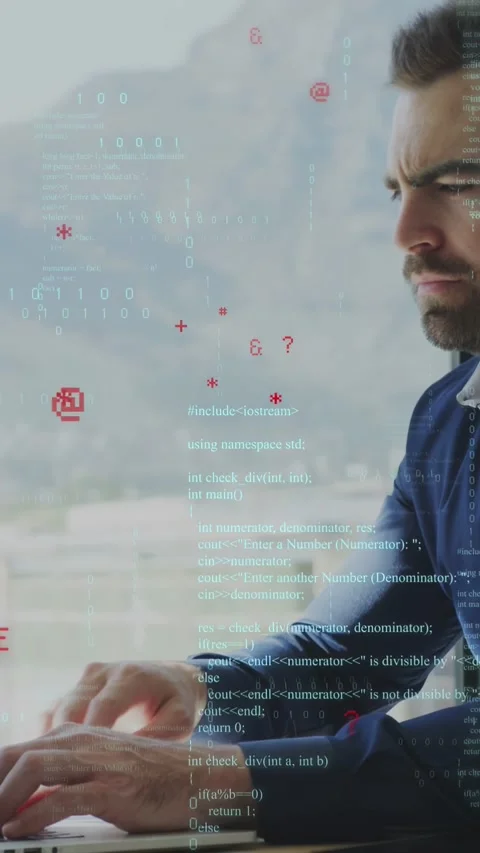 Vertical video: Man typing on laptop near window, starting code overlay and Stock Footage 335355225