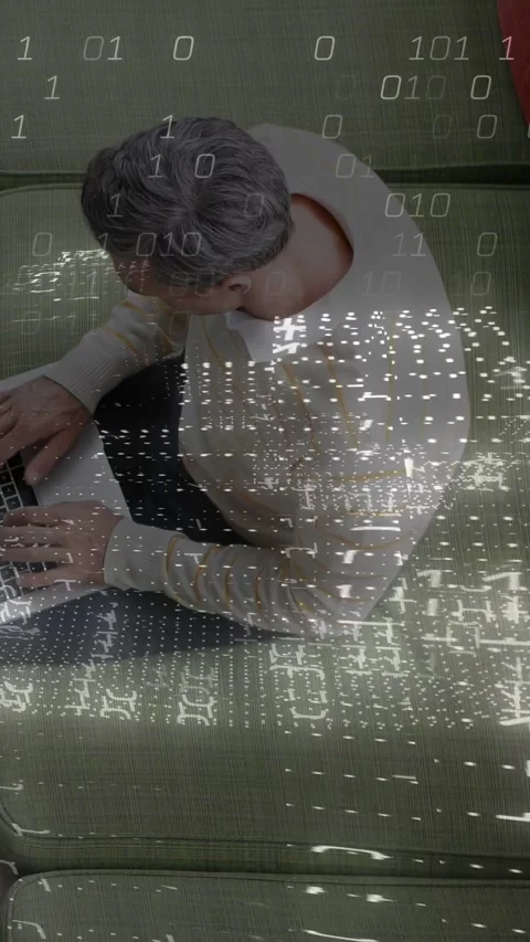 Vertical video: Man typing on laptop casting binary overlay pausing looking up Stock Footage 340133317