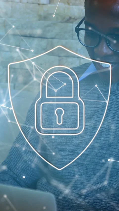 Vertical video: Man typing at table, hands moving revealing keys while shield Stock Footage 334836733