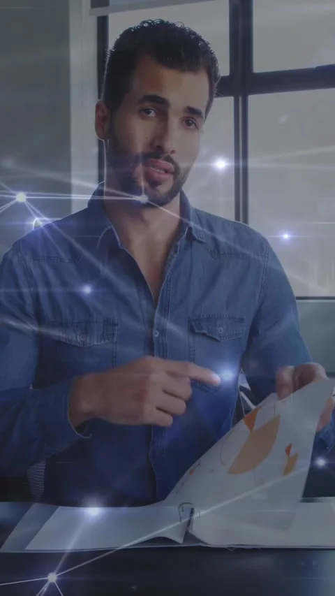 Vertical video: Man unfolding report, showing business data as particles Stock Footage 331162999