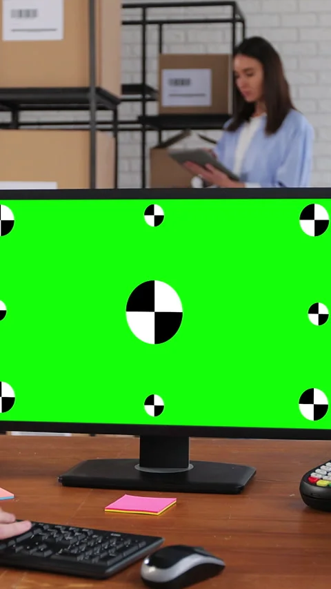 Vertical video. Man using desktop computer with green chromakey screen. Stock Footage 345738511