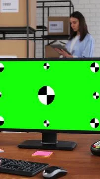 Vertical video. Man using desktop computer with green chromakey screen. A man Stock Photos
