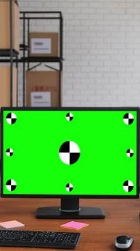 Vertical video. Man using desktop computer with green screen chromakey in the Stock Photos