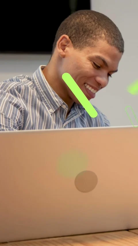 Vertical video: Man using laptop in tech, green shapes moving right causing Stock Footage 333181921