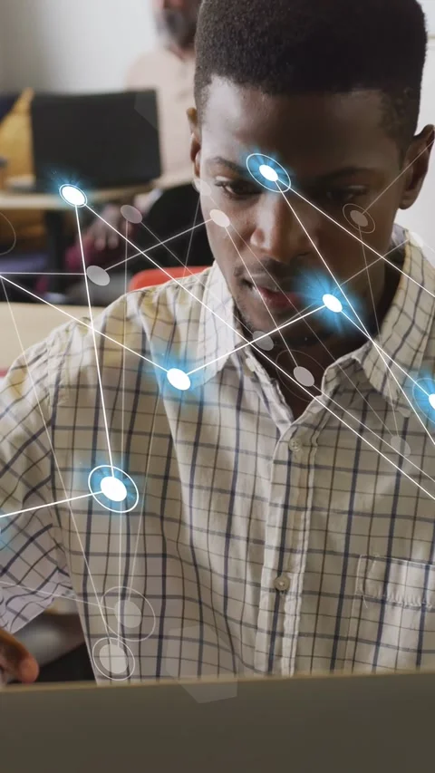 Vertical video: Man using laptop for tech study while nodes growing into dense Stock Footage 334704883