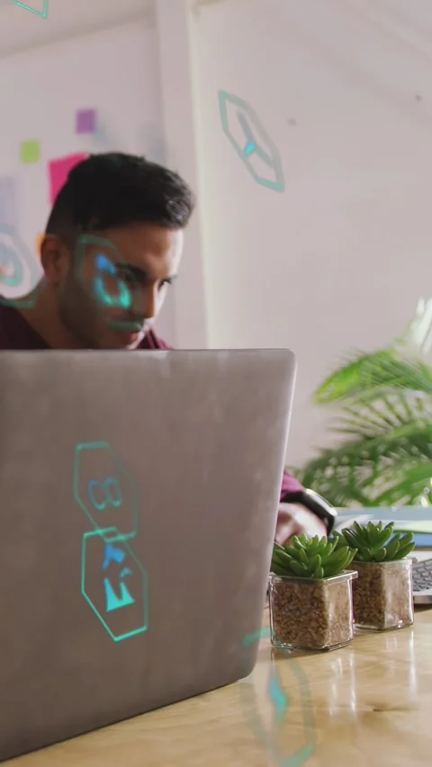 Vertical video: Man using mouse at tech desk, expanding holo UI above laptop Stock Footage 333541981