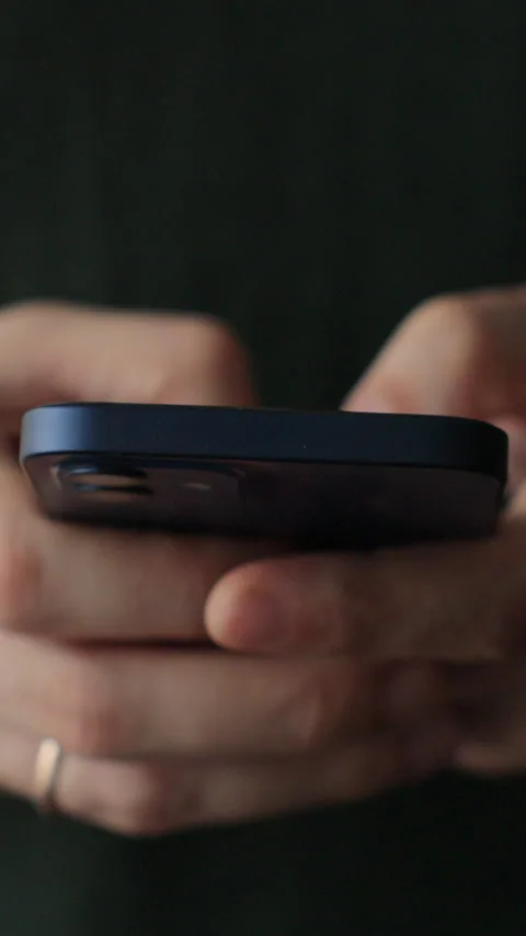 Vertical video. Man using smartphone at home. Stockbeeldmateriaal 343764179
