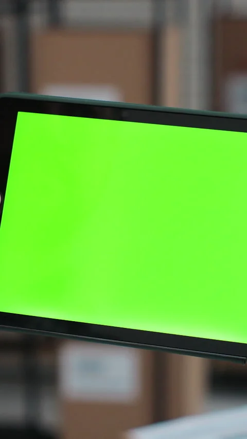 Vertical video. Man using tablet computer with green screen chromakey. Vidéo 345740347